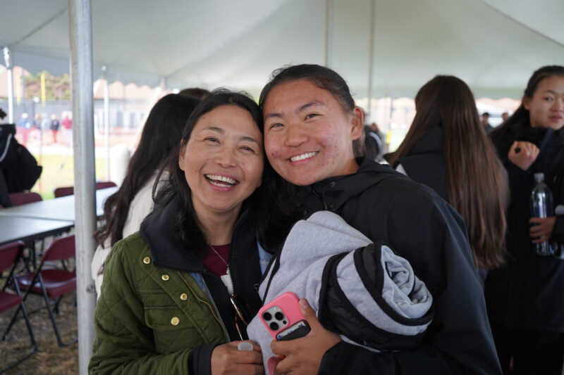 Mother and daughter smiling together.