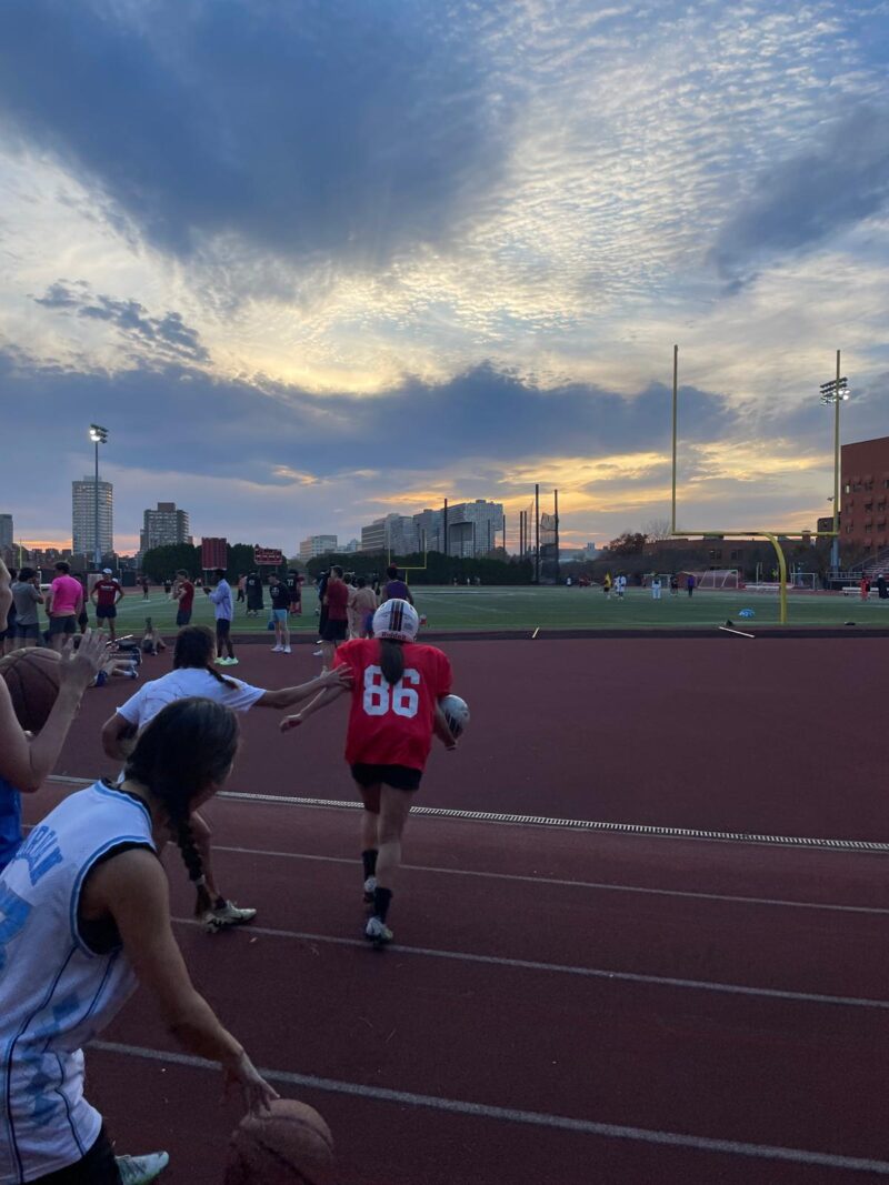 Girl dressed up as football player running.