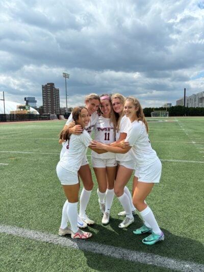 Soccer team hugging.