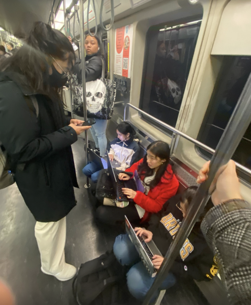 people sitting on the subway typing