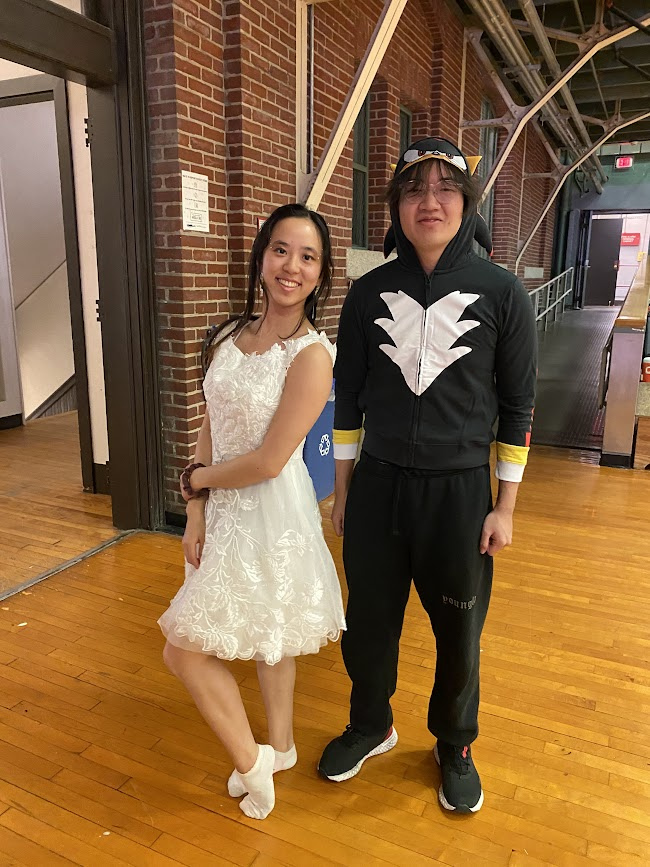 two people standing next to each other, one dressed in a white dress and the other dressed in a shadow sonic jersey