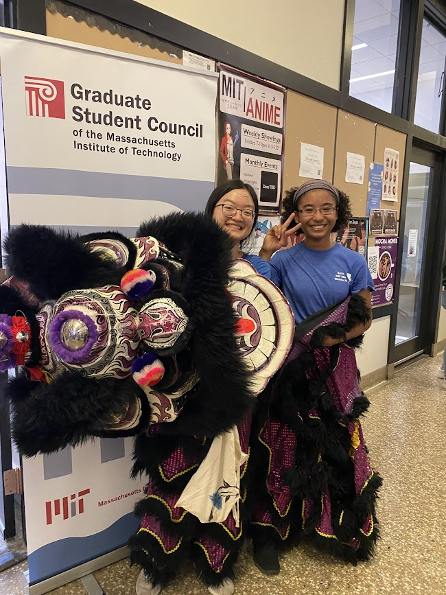 two people standing while the Lion Dance Costume is off