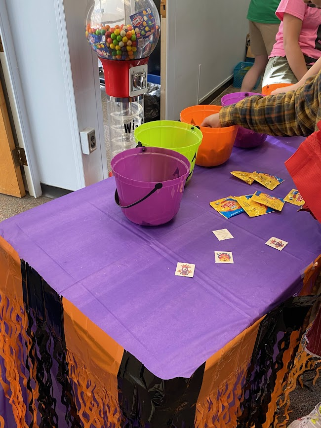 tables with stickers and a bucket of lollies on the top