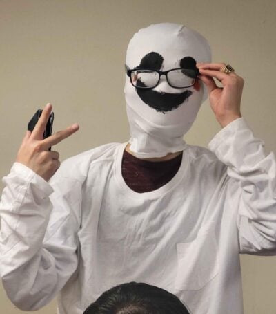 guy in a white mask with a black smile on it