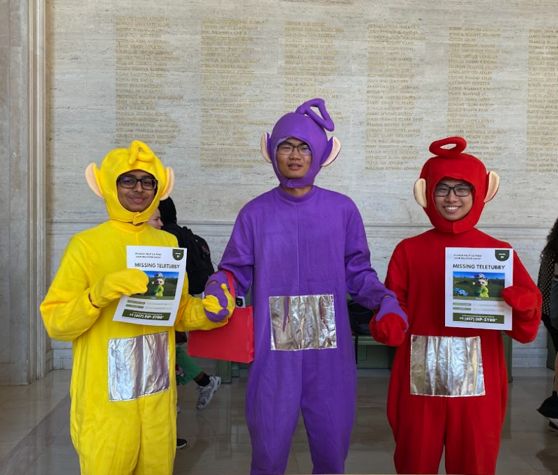 three people dressed up as the teletubbies holding up a