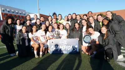 Team celebrating with trophy.