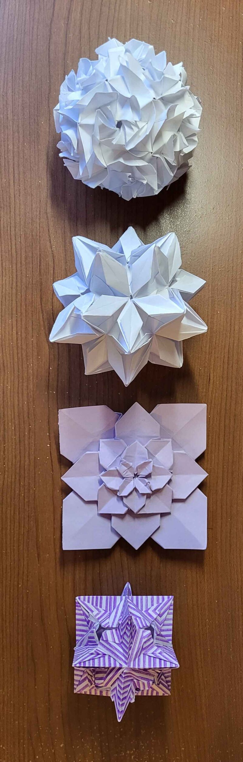 four origami polyhedra, various shades of purple