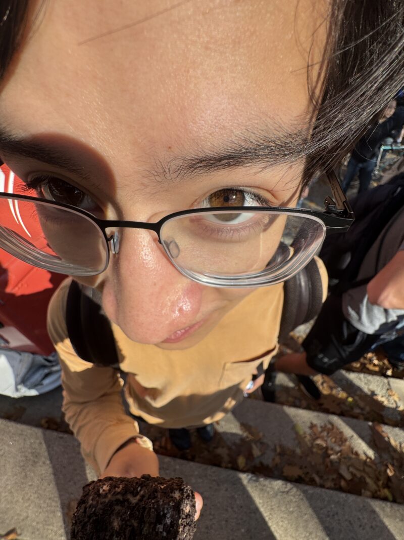 Overhead closeup forehead photo of a student eating ice cream.