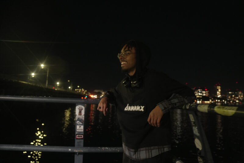 Photo of student standing and smiling on the Harvard Bridge.
