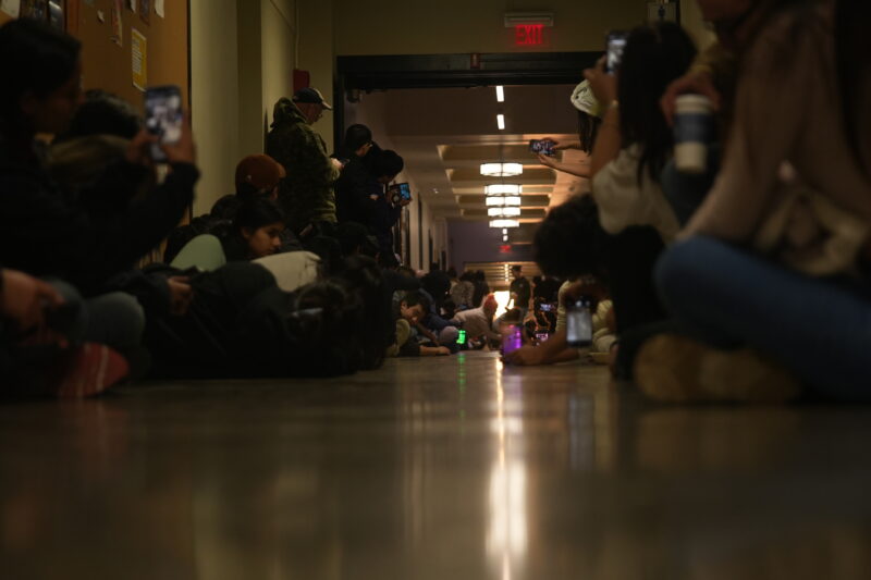 Photo of people lining up their phones in the hallway