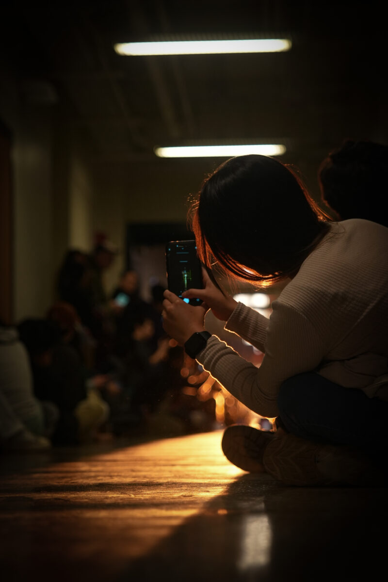 Photo of people leaning in to take photos of the sun