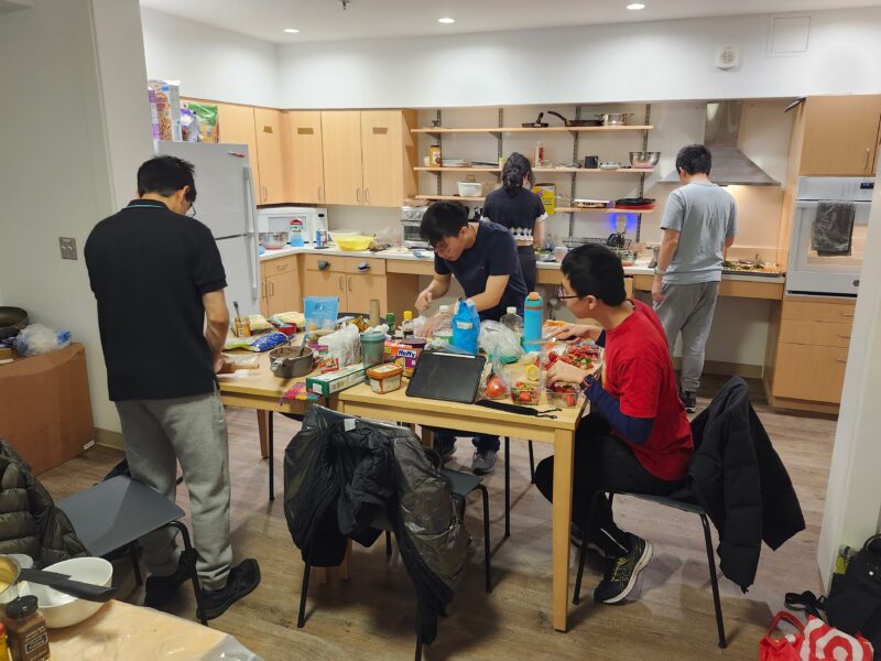 five people working in a kitchen