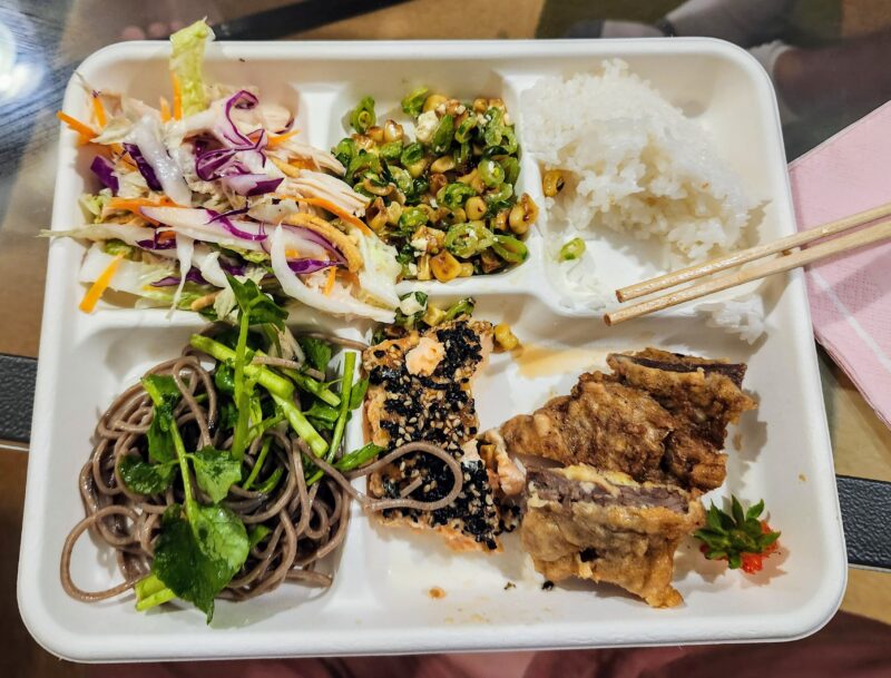 chinese chicken salad, snapea salad, white rice, soba salad, furikake salmon, & meat jun on a plate
