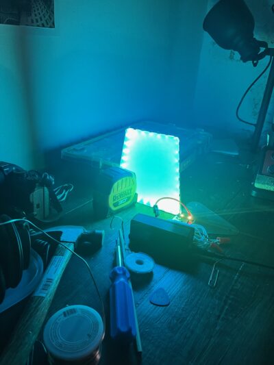 A rectangular acrylic panel glowing blue