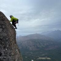 person climbing a rock face