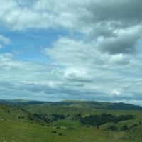 rolling green hills, blue skies, and windmills