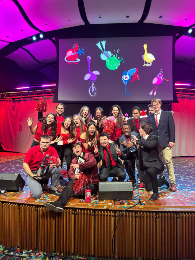 Team members on a large stage surrounded by confetti.