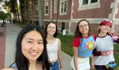 Four girls including Sarah, my first guest, and I standing on the sidewalk smiling.