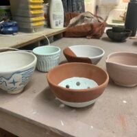 a picture of 5 glazed pottery vessels