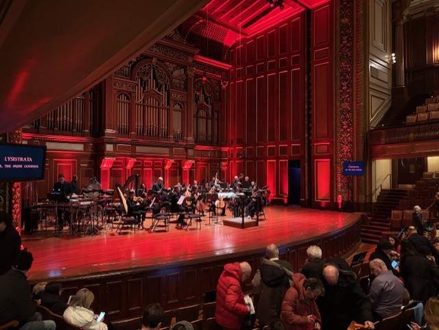 Big stage with musicians and a conductor