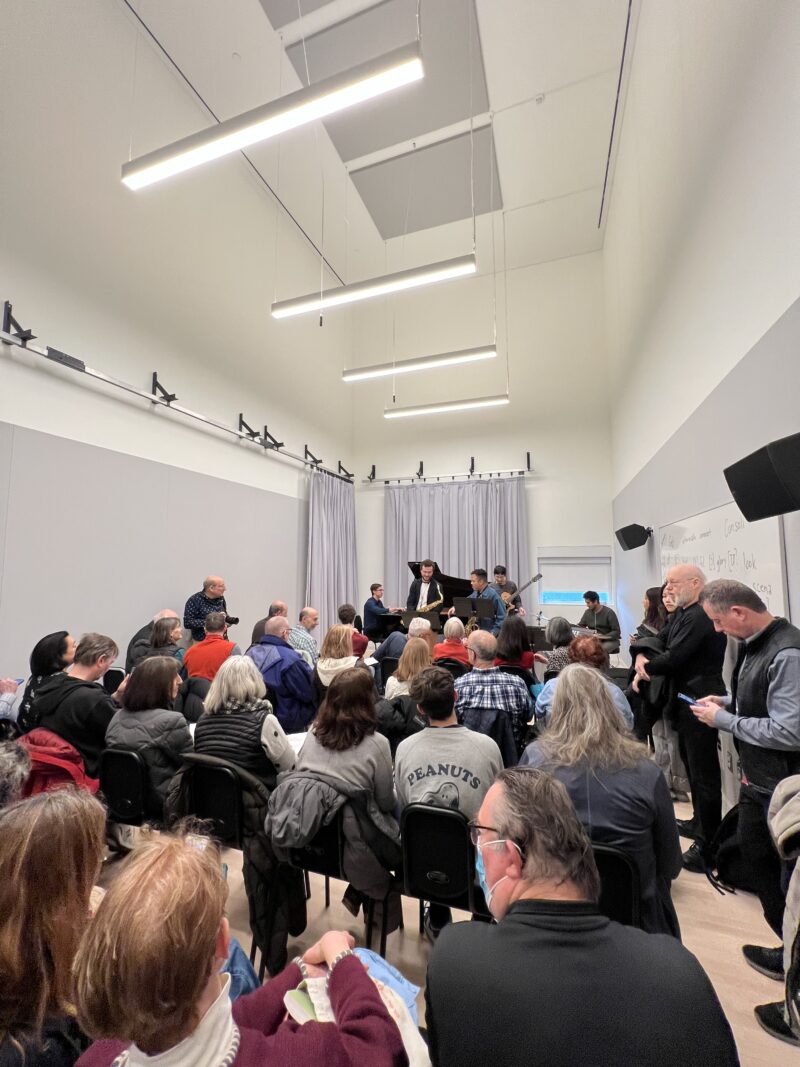 A room filled with attendees for a student jazz performance in the new MIT Jae S. and Kyuho Lim Music Maker Pavilion.