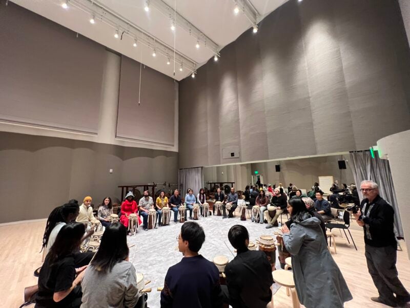 Participant join in a Senegalese drumming workshop in the new music and culture space.