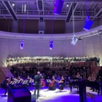 An ensemble of musician and vocalists performing in Tull Concert Hall.