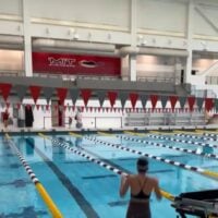 Person jumping into pool.