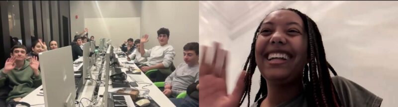 A screenshot of a virtual meeting shows a group of students in a computer lab on the left side of the image, waving at the camera. They are seated at a long table with desktop computers, keyboards, and other electronic equipment. On the right side, a smiling woman with braided hair is also waving, appearing to be joining the session remotely. The names