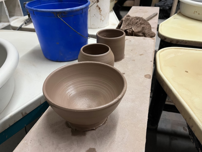 a picture of a bat with three clay pots on it