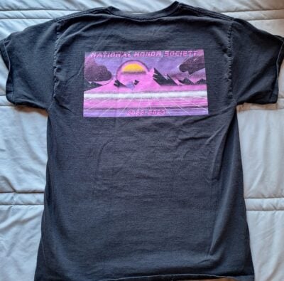 The back of a black-shirt with a futuristic purple-landscape with a mountain range and sunset in the back. The top reads "National Honor Society".