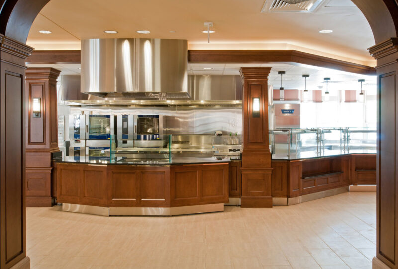 The entrance to a dining hall with a long wood counter going across.