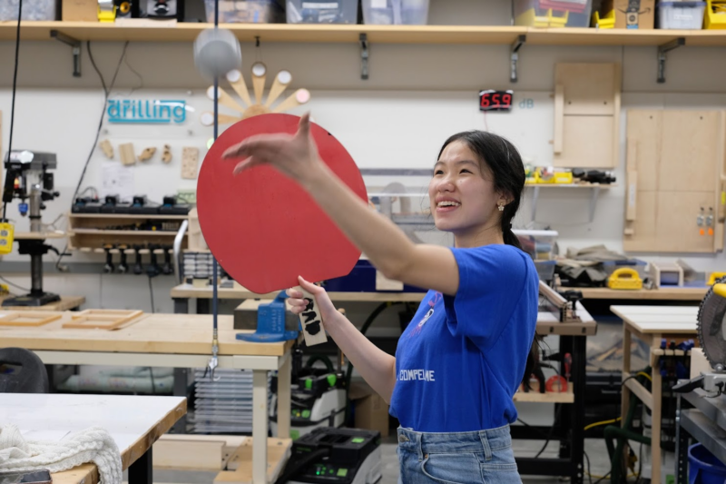 me serving with a giant ping pong ball and paddle
