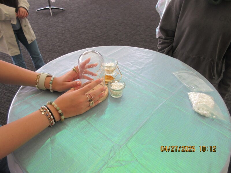 a photo of hands clasping a light on a table