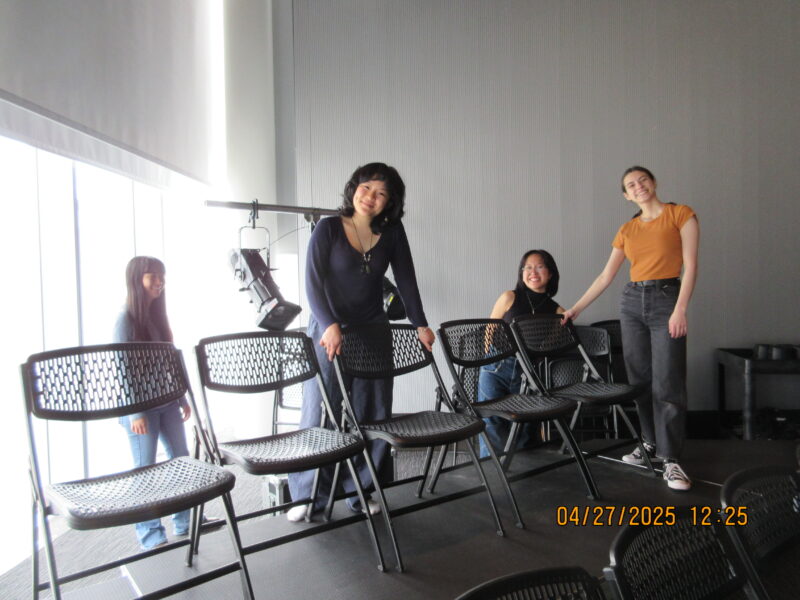 some people smiling next to the chairs