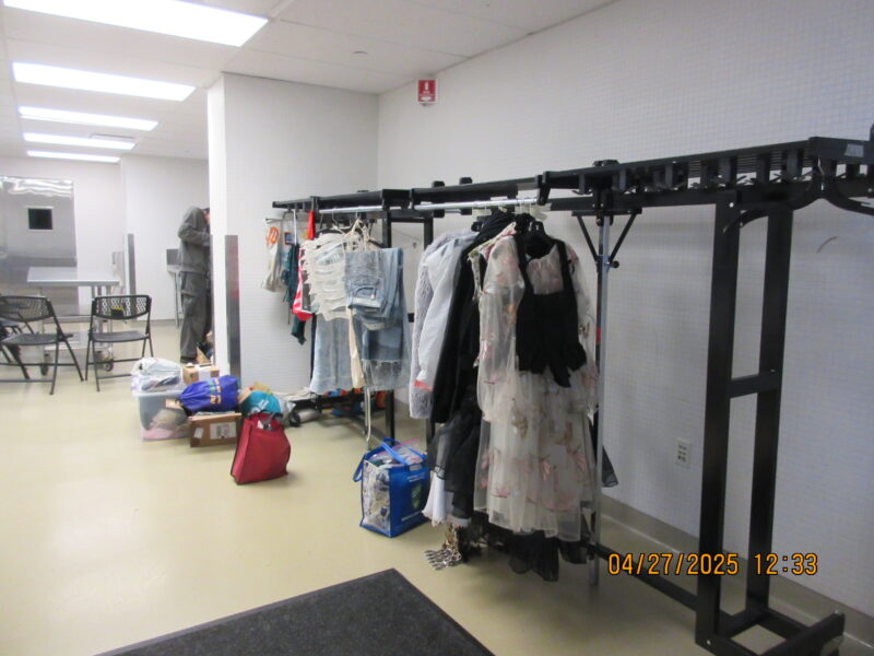 a coat rack with many garments on it