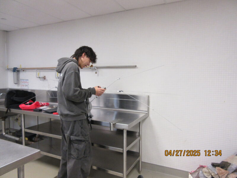 a guy fiddling with a mechanical structure