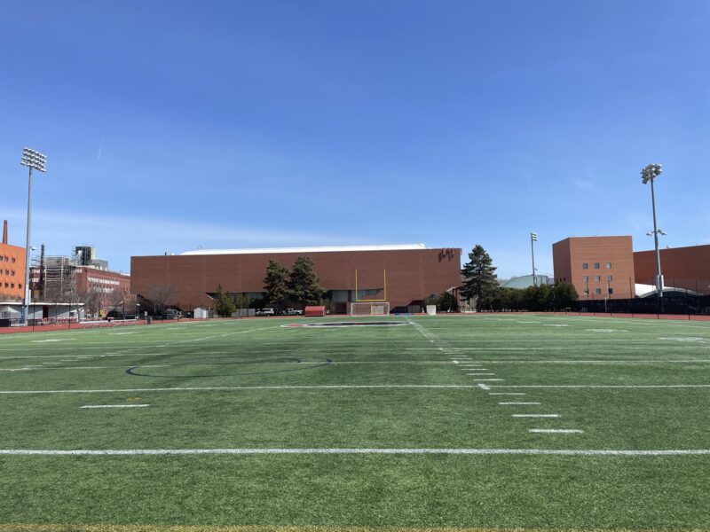 Picture taken on turf soccer field with building in background.