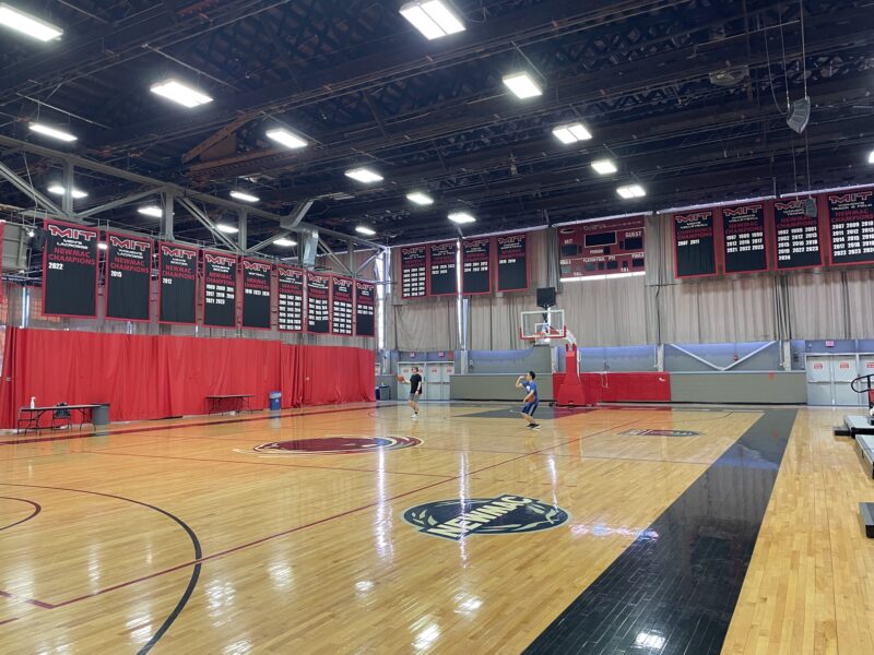 Basketball court with red curtains dividing the courts.