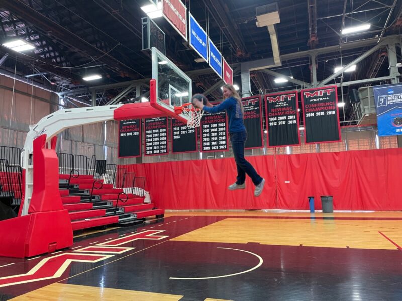 Girl edited so that it looks like she is dunking on a basketball hoop.