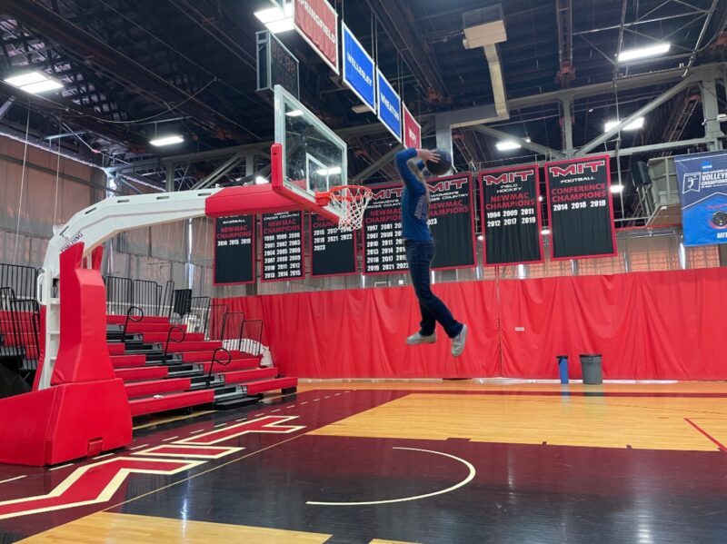 Girl edited so that it looks like she is dunking on a basketball hoop.