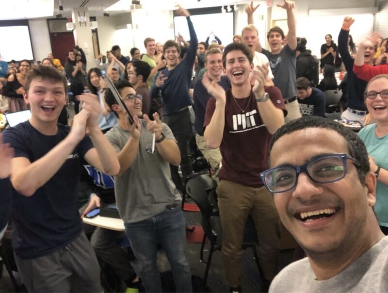 Photo of a physics professor taking a selfie with students in a classroom after a review session