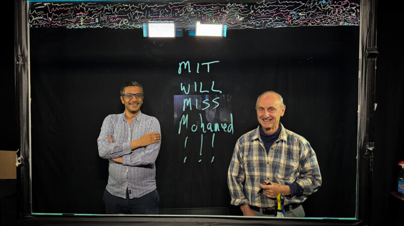 Photo of Peter writing a message on the lightboard saying
