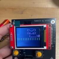 A circuit board with a screen showing a pixelated rabbit.