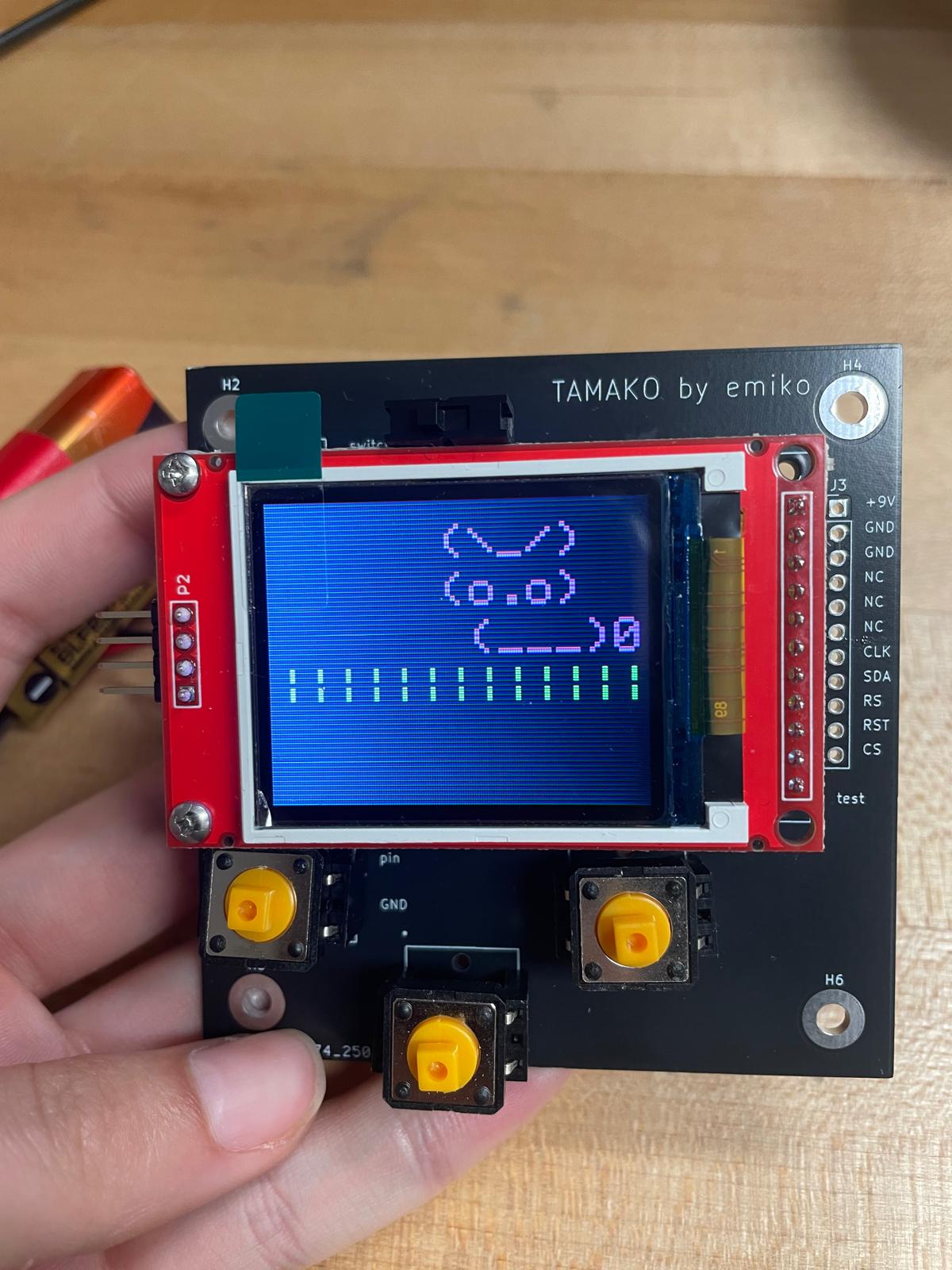 A circuit board with a screen showing a pixelated rabbit.