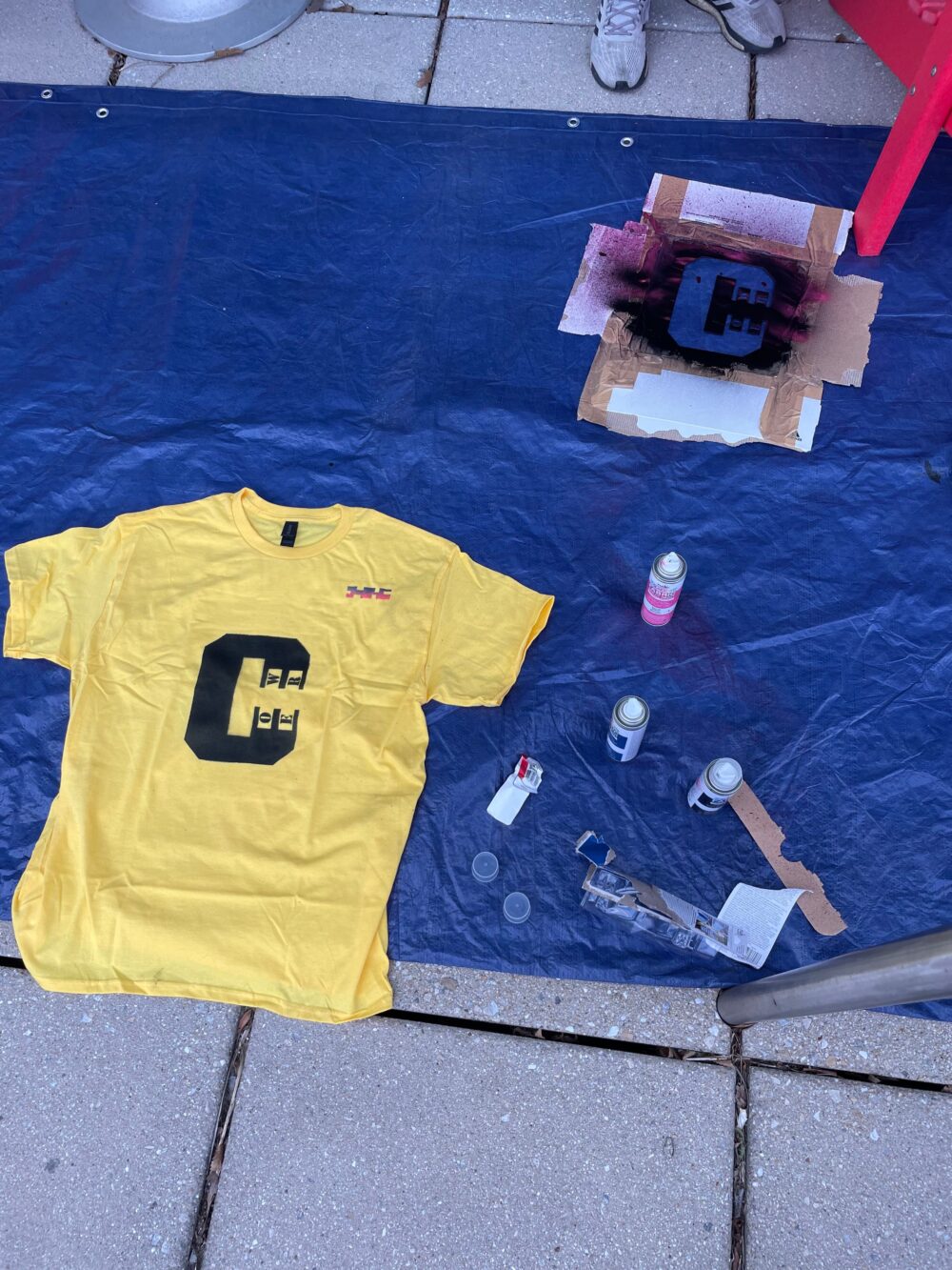 spray painted shirt that says C tower
