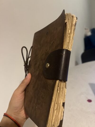 my brown leather notebook, it's tattered pages bound by a single cord