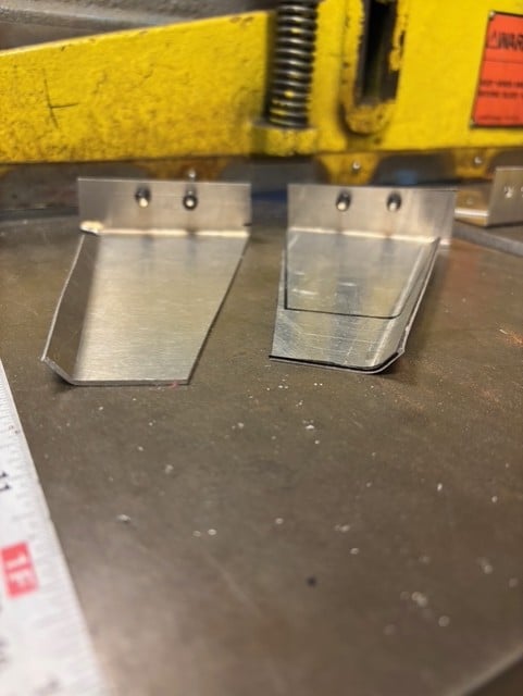 Manufactured wings with a turned up end, to create more lift.