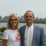 Raul Radovitzky and Flavia Cardarelli standing with the Boston cityscape in the background.