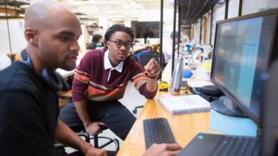 Students reviewing a computer screen together.